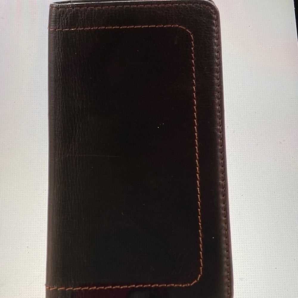 Vintage Louis Vuitton brown leather bifold wallet.